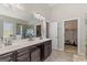 Main bathroom with double vanity, tile floors, and access to the closet and exercise area at 266 Shellbark Dr, Mcdonough, GA 30252