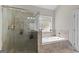 Modern bathroom featuring a large walk-in shower and a soaking tub at 266 Shellbark Dr, Mcdonough, GA 30252