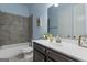 Bathroom featuring a large vanity, a toilet, a tub with shower, and light blue walls at 266 Shellbark Dr, Mcdonough, GA 30252