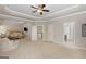 Large main bedroom with sitting area, tray ceilings, two closets, and access to the main bathroom at 266 Shellbark Dr, Mcdonough, GA 30252
