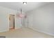 Spacious bedroom with neutral carpet, double doors, and a swing feature at 266 Shellbark Dr, Mcdonough, GA 30252