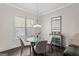 Cozy breakfast nook featuring a glass table, neutral chairs, and bright natural light at 266 Shellbark Dr, Mcdonough, GA 30252