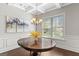 Elegant dining room with coffered ceiling, large window, and a classic wooden table at 266 Shellbark Dr, Mcdonough, GA 30252