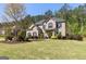 Charming two-story brick home with a manicured lawn, lush landscaping, and classic black shutters at 266 Shellbark Dr, Mcdonough, GA 30252