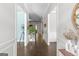 Hallway with hardwood floors and white trim showcasing an open, light-filled entryway at 266 Shellbark Dr, Mcdonough, GA 30252