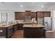 Gourmet kitchen featuring dark wood cabinetry, granite countertops, and stainless steel appliances at 266 Shellbark Dr, Mcdonough, GA 30252