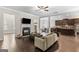 Spacious living room featuring a fireplace, dark hardwood floors, and seamless flow into other living spaces at 266 Shellbark Dr, Mcdonough, GA 30252