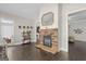 Open living room features a stone fireplace, hardwood floors, and seamless flow into other living spaces at 266 Shellbark Dr, Mcdonough, GA 30252
