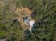 Aerial view of a secluded home surrounded by lush greenery, showcasing the property's privacy at 671 Ellison Rd, Tyrone, GA 30290