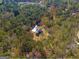 Aerial view of the home with a spacious lot, surrounded by lush greenery and mature trees at 671 Ellison Rd, Tyrone, GA 30290