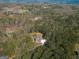 An aerial shot of the property nestled within a dense forest of mature trees, offering privacy and seclusion at 671 Ellison Rd, Tyrone, GA 30290
