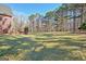 Expansive backyard featuring lush green grass and mature trees, perfect for outdoor activities and enjoying nature at 671 Ellison Rd, Tyrone, GA 30290