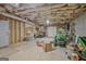 Unfinished basement with visible framework and a garage door, providing ample space for customization at 671 Ellison Rd, Tyrone, GA 30290
