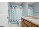 Bathroom featuring a single vanity with granite countertops and a shower/bath combo with a decorative curtain at 671 Ellison Rd, Tyrone, GA 30290