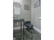 Stylish powder room featuring a glass bowl sink and black toilet, complemented by decorative wall art at 671 Ellison Rd, Tyrone, GA 30290