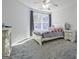 Bright bedroom with a large window and neutral gray carpet offers a cozy and relaxing space at 671 Ellison Rd, Tyrone, GA 30290