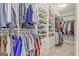 Spacious walk-in closet with custom shelving, hanging rods, and drawers for optimal storage and organization at 671 Ellison Rd, Tyrone, GA 30290