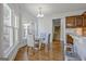 Light filled dining area with a modern chandelier, large windows, and a stairway entrance at 671 Ellison Rd, Tyrone, GA 30290