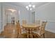 Formal dining room with hardwood floors, a chandelier, and views into other rooms at 671 Ellison Rd, Tyrone, GA 30290