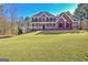 Charming two-story brick home with a covered front porch, surrounded by a spacious lawn at 671 Ellison Rd, Tyrone, GA 30290