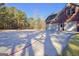 Brick home with a spacious driveway and basketball court, set against a backdrop of trees at 671 Ellison Rd, Tyrone, GA 30290
