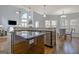 Spacious kitchen with an island, granite countertops, stainless steel appliances and a view into the living room at 671 Ellison Rd, Tyrone, GA 30290