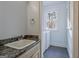 Compact laundry room including sink and natural light from a window at 671 Ellison Rd, Tyrone, GA 30290