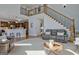 Open-concept living room with high ceilings, a staircase, and views of the kitchen for seamless entertaining at 671 Ellison Rd, Tyrone, GA 30290