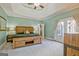 Light-filled main bedroom featuring wooden furniture, a tray ceiling, and access to an outdoor patio at 671 Ellison Rd, Tyrone, GA 30290