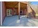 Covered patio with brick detailing featuring stairs leading to the backyard and an adjacent door at 671 Ellison Rd, Tyrone, GA 30290