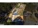 Aerial view of the property with swimming pool, red shed, and surrounding dense trees at 113 Elmwood Dr, Hampton, GA 30228