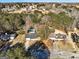 Aerial view of the property with swimming pool, red shed, and surrounding dense trees at 113 Elmwood Dr, Hampton, GA 30228