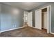 Spacious bedroom with plush carpet, offering comfort and style for a relaxing retreat at 113 Elmwood Dr, Hampton, GA 30228
