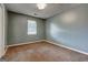 Neutral bedroom features a sun-filled window, providing ample natural light and a cozy atmosphere at 113 Elmwood Dr, Hampton, GA 30228