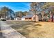 One-story brick home with attached garage surrounded by large front yard and mature trees at 113 Elmwood Dr, Hampton, GA 30228