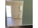 Bright kitchen showcasing modern appliances and ample counter space, viewed through an open doorway at 113 Elmwood Dr, Hampton, GA 30228