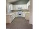 Spacious kitchen with white appliances and plenty of counter space at 113 Elmwood Dr, Hampton, GA 30228