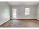 Neutral living room featuring carpet, white trim, a back door and one double hung window at 113 Elmwood Dr, Hampton, GA 30228