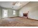 Open living room featuring a fireplace, carpet, white trim, a vaulted ceiling, and a ceiling fan at 113 Elmwood Dr, Hampton, GA 30228