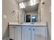 White bathroom vanity with double sinks and stone countertop at 1820 Cobblefield Cir, Dacula, GA 30019