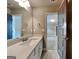 Bathroom vanity features stone countertop, large mirror, and modern fixtures at 1820 Cobblefield Cir, Dacula, GA 30019