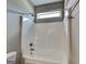 Bathroom featuring white shower and tub combo with neutral walls and bright lighting at 1820 Cobblefield Cir, Dacula, GA 30019