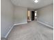 Large carpeted bedroom with multiple doorways and neutral wall paint at 1820 Cobblefield Cir, Dacula, GA 30019