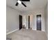 Bedroom featuring neutral carpet and multiple doors with dark trim and hardware at 1820 Cobblefield Cir, Dacula, GA 30019