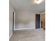 Bedroom featuring neutral carpet and doors with dark trim and hardware at 1820 Cobblefield Cir, Dacula, GA 30019
