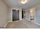 Carpeted bedroom includes large closet doors, recessed lighting, and ensuite bathroom at 1820 Cobblefield Cir, Dacula, GA 30019