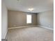 Carpeted bedroom with a window and neutral wall paint at 1820 Cobblefield Cir, Dacula, GA 30019