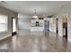 Open-concept living area with hardwood floors, neutral walls, and access to the kitchen at 1820 Cobblefield Cir, Dacula, GA 30019