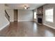 Bright and spacious living room with hardwood flooring, fireplace, and staircase at 1820 Cobblefield Cir, Dacula, GA 30019