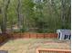 Spacious backyard with a wooded view, fenced in yard and a small shed at 1581 Shetland Pony Nw Ct, Suwanee, GA 30024